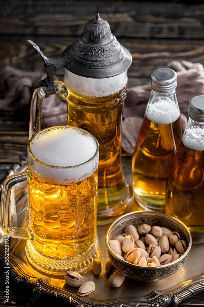 Light beer in a glass on a table in composition with accessories on an old background Light beer in a glass on a table in composition with accessories on an old background