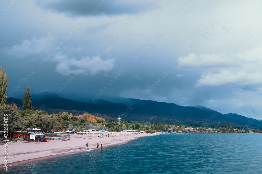 Issyk-kul beach with overcast mountains at the back