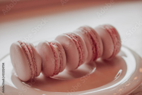 Strawberry french macarons closeup. Fresh and colourful on pink background