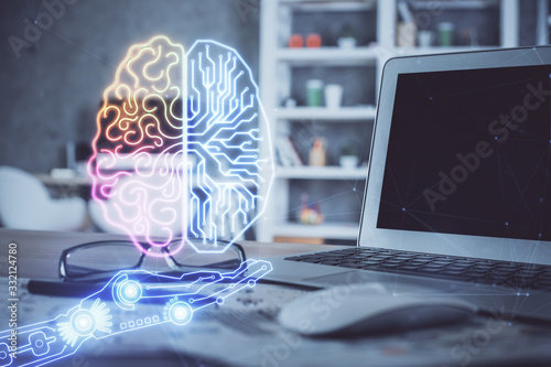 Double exposure of table with computer and brain hologram. Data innovation concept.
