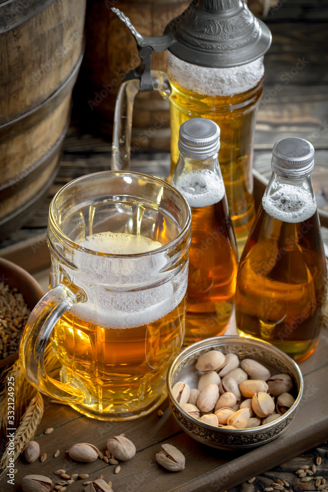Light beer in a glass on a table in composition with accessories on an old background Light beer in a glass on a table in composition with accessories on an old background
