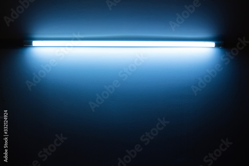 Blue neon lamp on a white wall