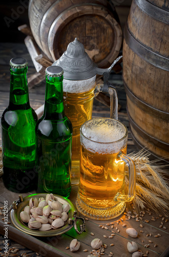 Light beer in a glass on a table in composition with accessories on an old background