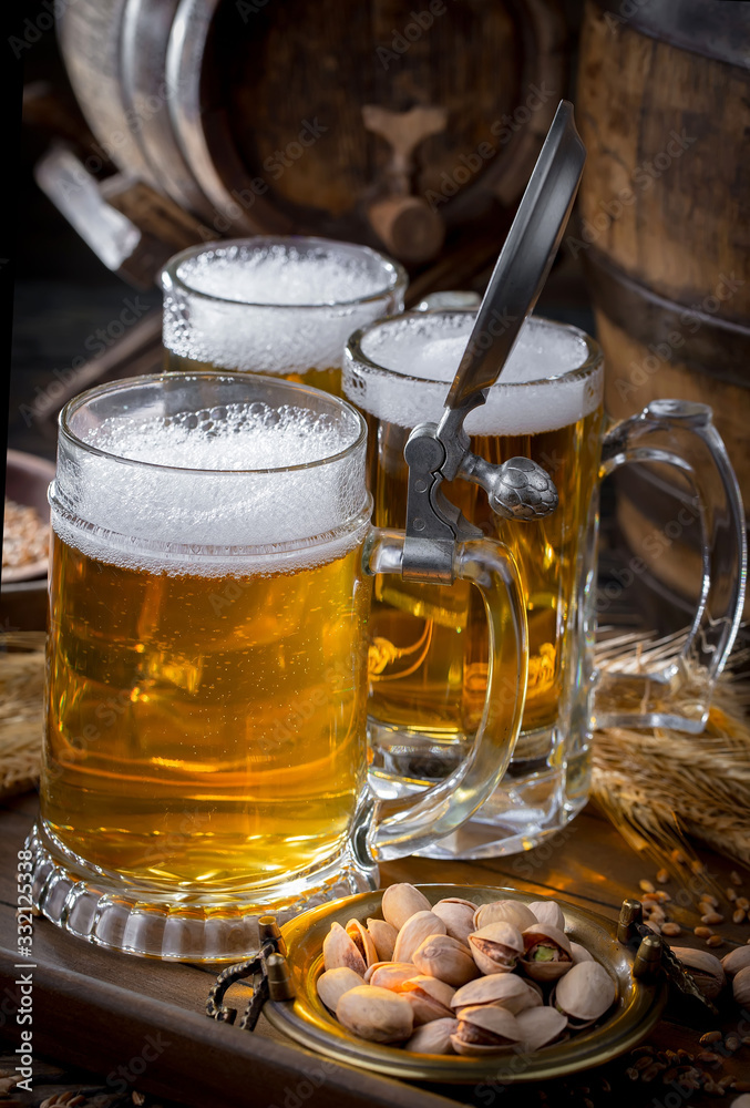 Light beer in a glass, on an old background. Light beer in a glass, on an old background.