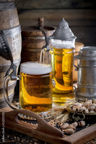 Light beer in a glass on a table in composition with accessories on an old background