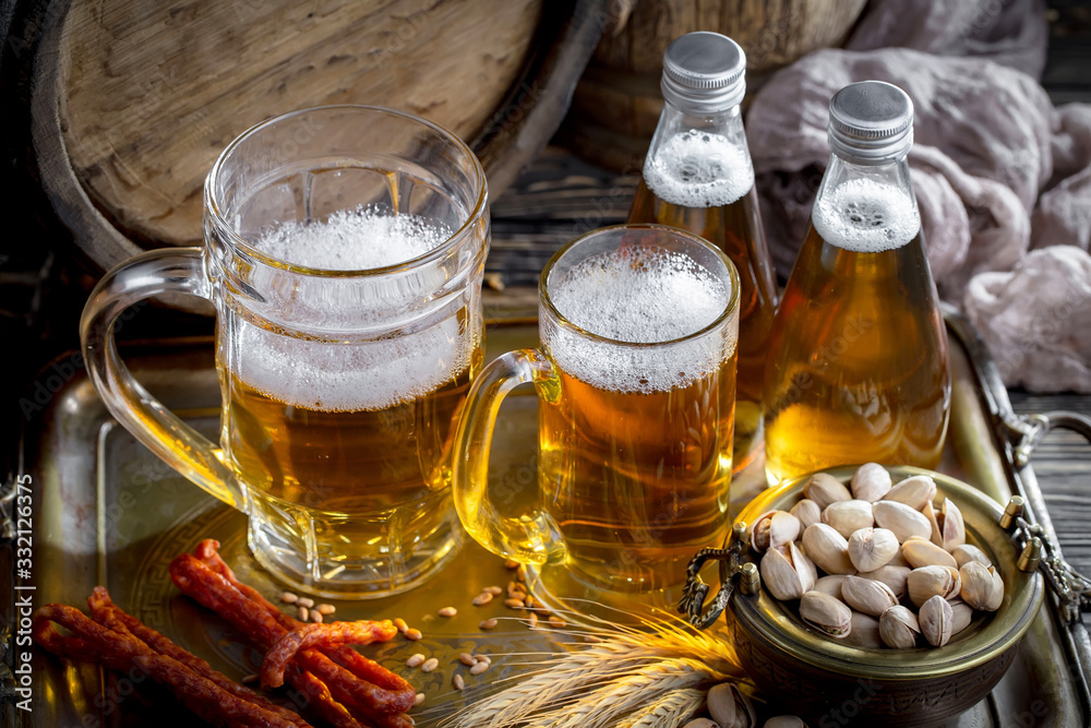 Light beer in a glass on a table in composition with accessories on an old background Light beer in a glass on a table in composition with accessories on an old background