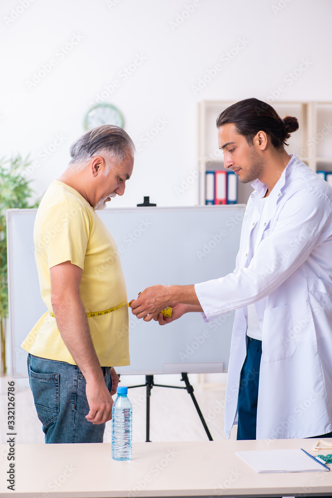 Fototapeta premium Doctor dietician giving advices to fat overweight patient