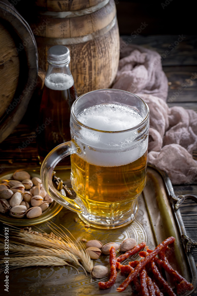 Light beer in a glass on a table in composition with accessories on an old background Light beer in a glass on a table in composition with accessories on an old background
