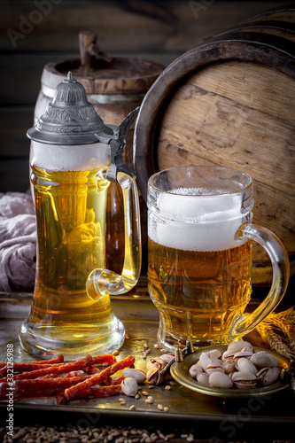 Light beer in a glass on a table in composition with accessories on an old background