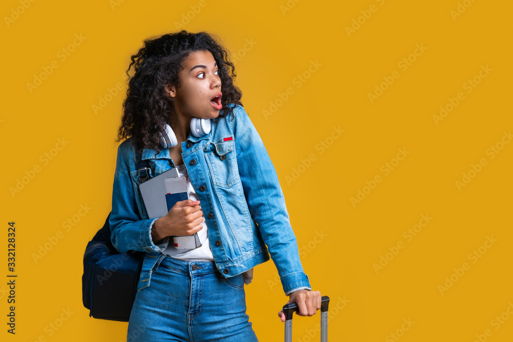 Beautiful dark skinned female tourist isolated on bright colored background Beautiful dark skinned female tourist isolated on bright colored background
