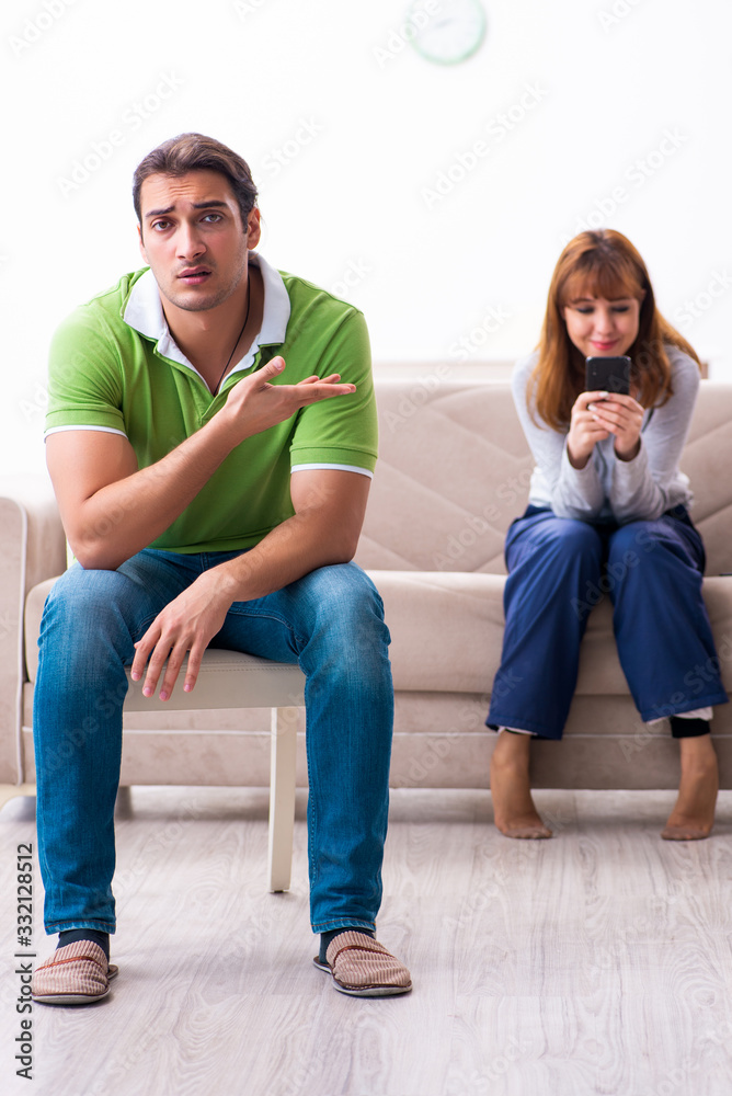 Young couple in gadget dependency concept