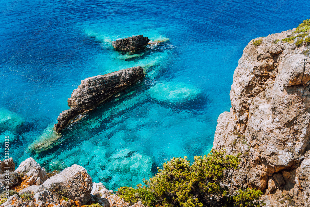 Rock cliffs and clear water at mediterranean sea coast. Greece