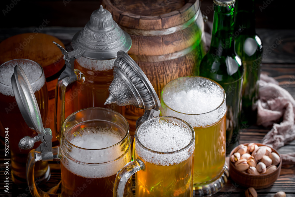 Light beer in a glass on a table in composition with accessories on an old background Light beer in a glass on a table in composition with accessories on an old background