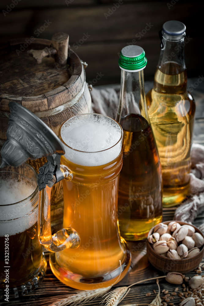 Light beer in a glass, on an old background. Light beer in a glass, on an old background.