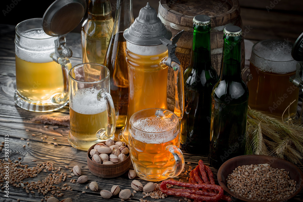 Light beer in a glass on a table in composition with accessories on an old background Light beer in a glass on a table in composition with accessories on an old background