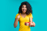 Attractive young african american woman with gift box in hands