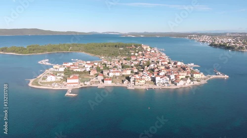 Drone fly over Krapanj little island of mediterranean See in Europe Croatia with a small town in a cloudy day of summer, travel destination photo