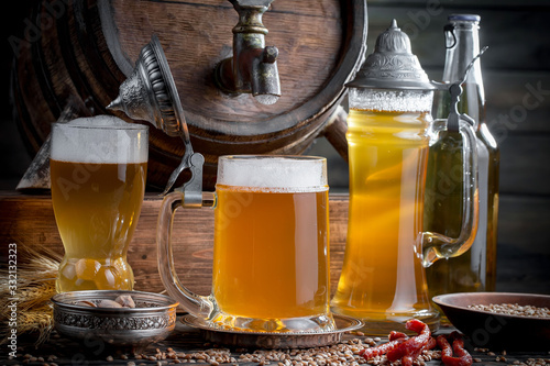 Light beer in a glass, on an old background.