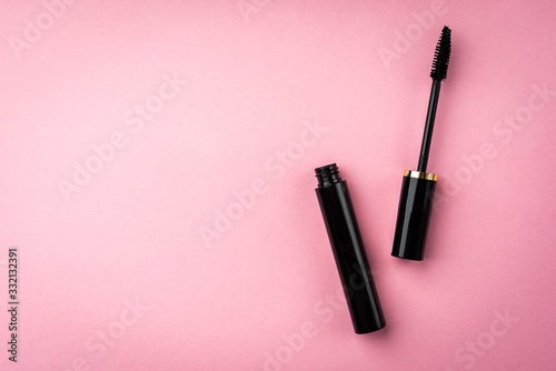 Mascara on pink background. Basic products for eyelashes makeup. photo