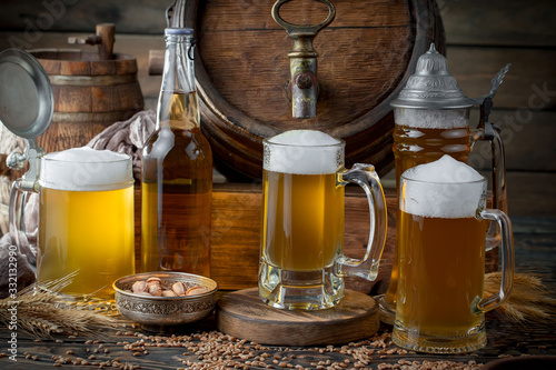 Light beer in a glass on a table in composition with accessories on an old background