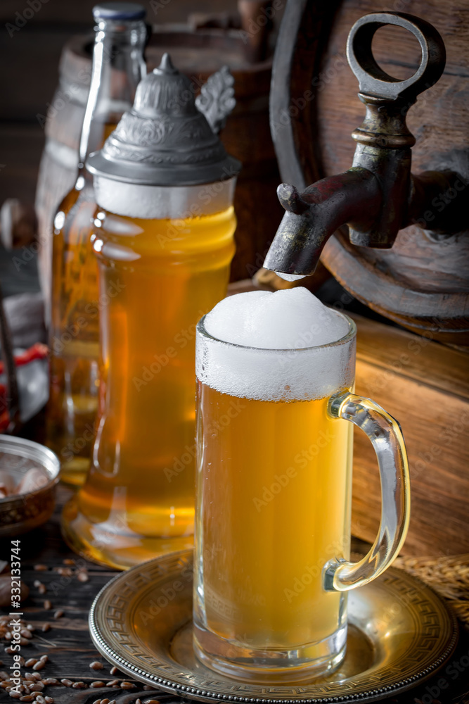 Light beer in a glass on a table in composition with accessories on an old background