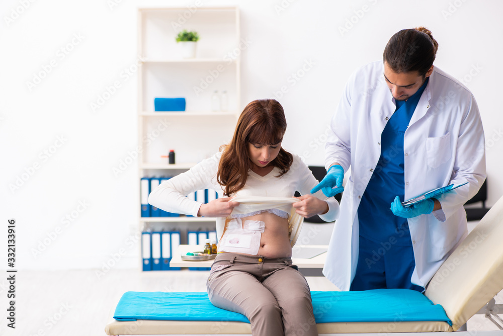 Injured young woman visiting young male doctor Injured young woman visiting young male doctor