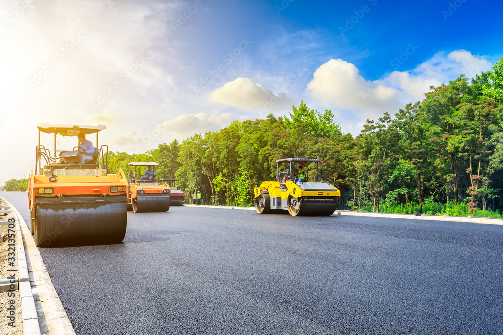 Obraz premium Construction site is laying new asphalt road pavement,road construction workers and road construction machinery scene.highway construction site landscape.