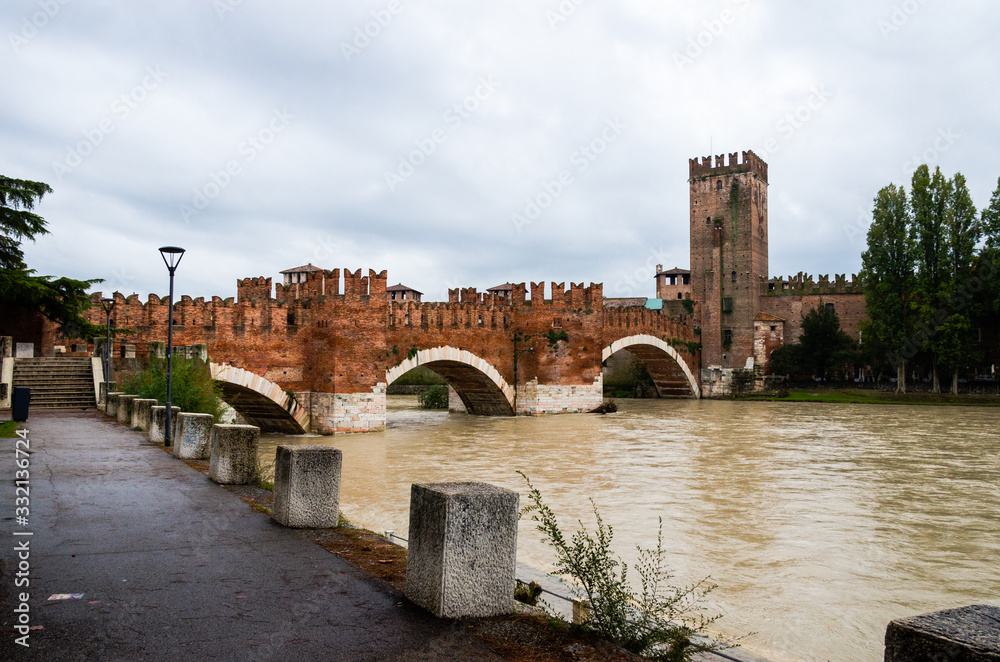 Castelvecchio Bridge in Verona during heavy rain and flooding.