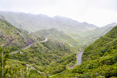 Serpentine road in the mountains of north of Tenerife. Park Rural de Anaga, Canary island, Spain. Rainy weather and low clouds.
