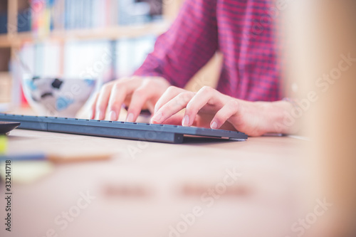 Home office concept: Man is working in home office, tying on keyboard