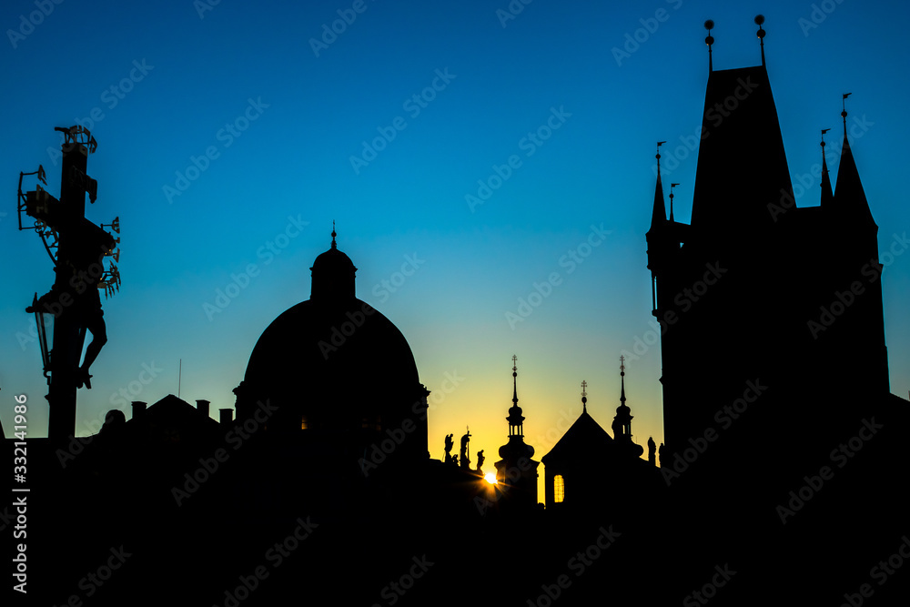 Prague Silhouette of rooftops of old town during clear sky sunrise photographed from Charles Bridge 
