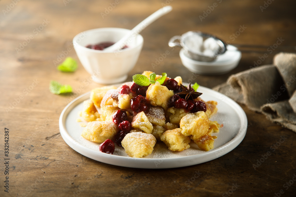 Traditional Austrian pancake dessert with cherry sauce Traditional Austrian pancake dessert with cherry sauce