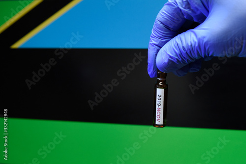 Corona virus or Covid-19 in Zanzibar , sample blood tube in hand with Zanzibar flag on background