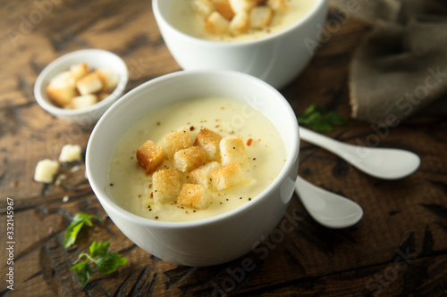 Homemade warming cheese soup with croutons 