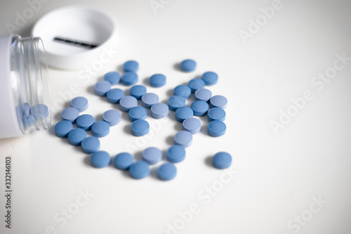 Blue pills on white background photo