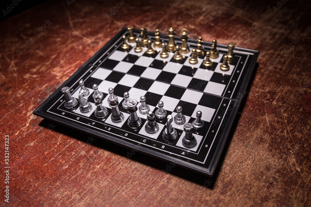 Chess figures on a dark background with smoke and fog. Selective focus Chess figures on a dark background with smoke and fog. Selective focus