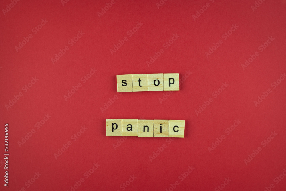 The inscription Stop Panic of wooden cubes on a red background. The inscription Stop Panic of wooden cubes on a red background.