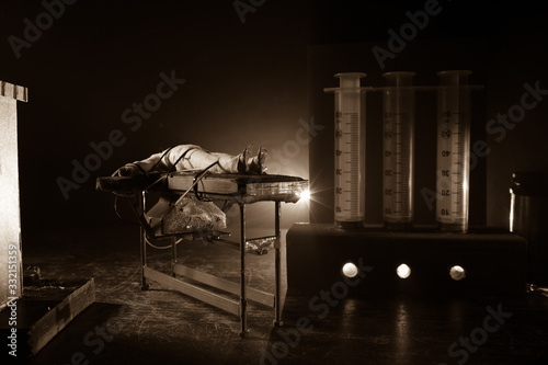 Prisoner handcuffed to death by lethal injection, vial with sodium thiopental and syringe on top of a table, conceptual image photo