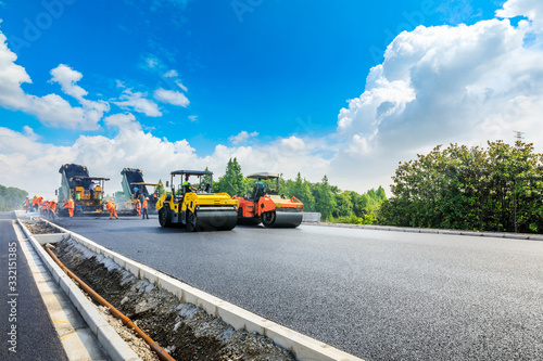 Wallpaper Mural Construction site is laying new asphalt road pavement,road construction workers and road construction machinery scene.highway construction site landscape. Torontodigital.ca