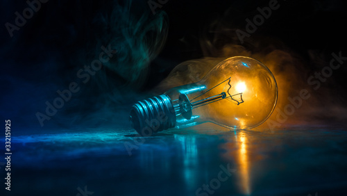 Abstract dark background with creative artwork decoration of glowing bulbs. photo