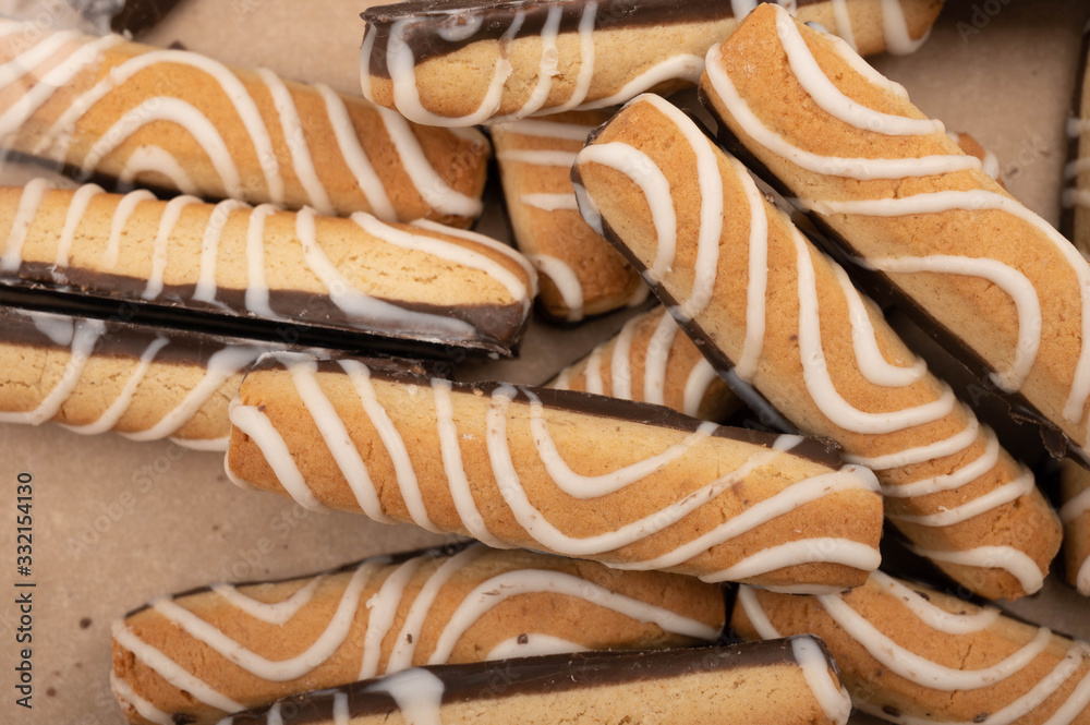 Sticks of cookies covered with chocolate and white icing. Close up. Sticks of cookies covered with chocolate and white icing. Close up.