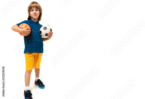 sport winner boy holding a soccer and basketball ball in his hands on a white background with copy space