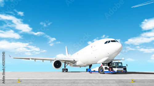 towing cargo airplane to airport runway wide panorama landscape with modern tow tractor on nose gear against clouds blue sky background Aircraft moving by truck Airport overview with cargo plane