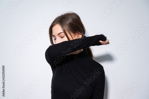 a girl in black clothes putting a black medicinal mask 