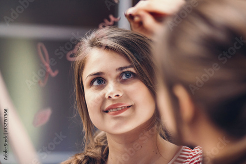 reflection of young woman writing with cosmetic pencil words "I love you" in mirror, portrait of romantic cute girl, concept declaration of love