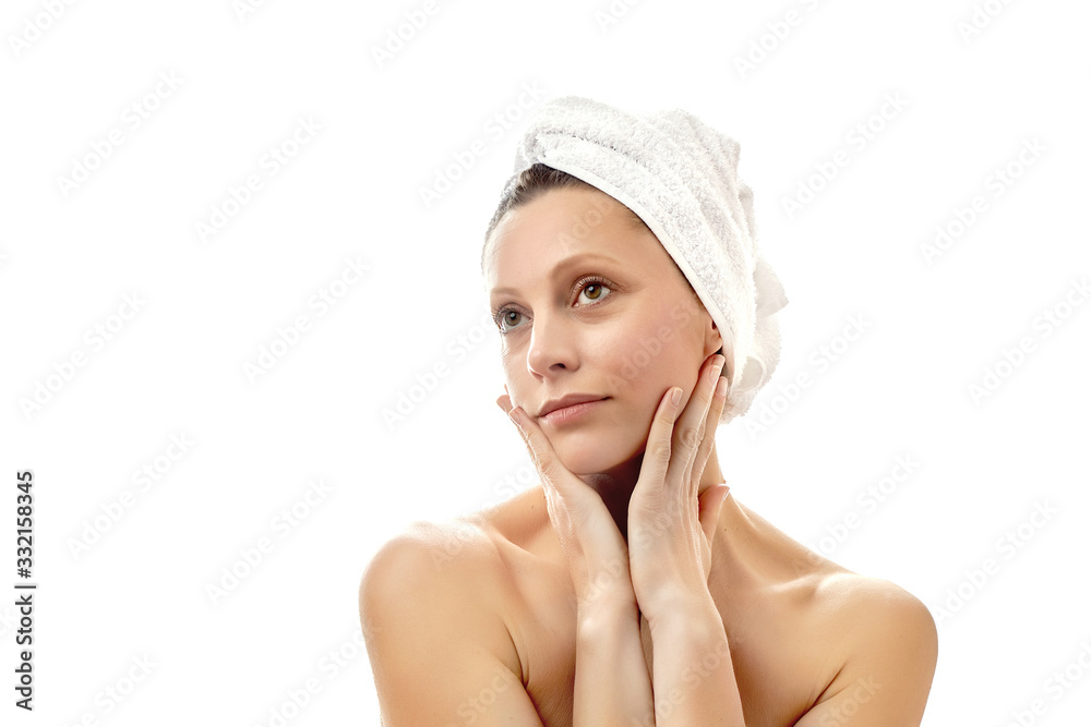 Beautiful young woman with a white towel on her head and with clean perfect skin. Facial massage at home, massage, wrinkle smoothing. Isolated white background. Isolated white background. Beautiful young woman with a white towel on her head and with clean perfect skin. Facial massage at home, massage, wrinkle smoothing. Isolated white background. Isolated white background.