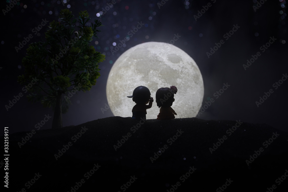 Young couple in love at beautiful moon of night.