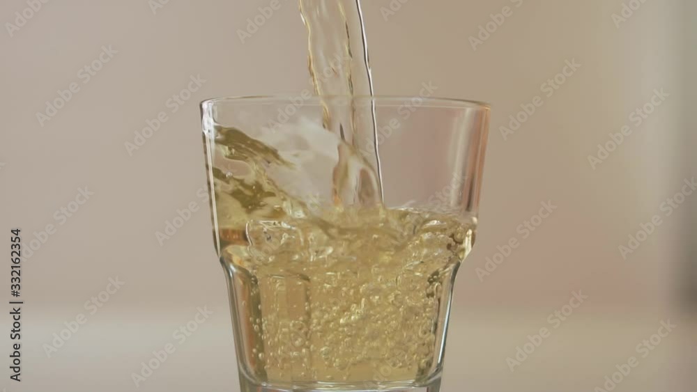 Pouring the juice into the glass, slow motion Pouring the juice into the glass, slow motion