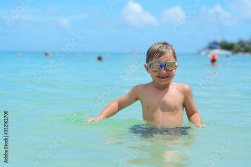 happy blond boy swimming in the sea, Mauritius