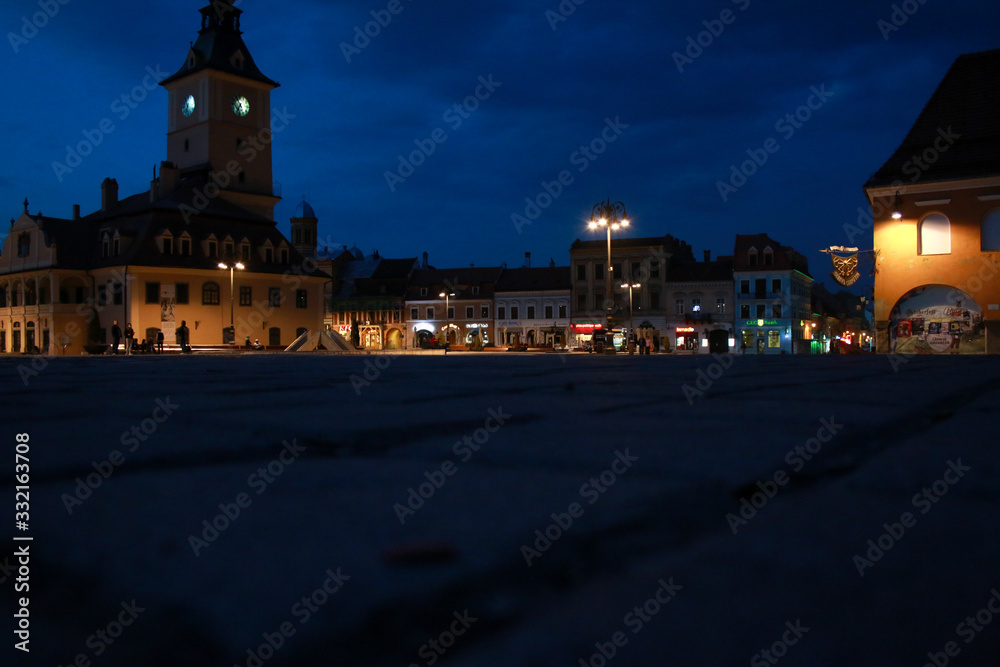 Brasov's old city town square in the night, empty because of the coronavirus outbreak.